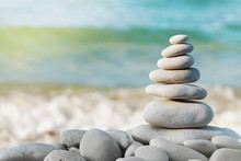 Stack Of White Pebbles Stone Against Blue Sea Background For Spa, Balance, Meditation And Zen Theme.