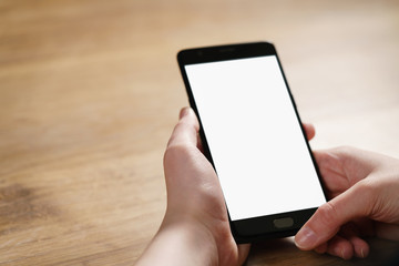 female teen hand holding smartphone with blank white screen