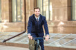 © Africa Studio - Handsome young businessman riding bicycle outdoors