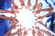 © Africa Studio - Team of volunteers putting their hands together as symbol of unity, bottom view