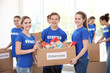 © Africa Studio - Young volunteers with box of donations indoors