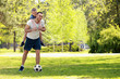 © Africa Studio - Father and son playing football on green grass in park