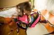 © Кирилл Рыжов - Image from high point of cute schoolgirl looking inside of her backpack