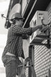 © Кирилл Рыжов - Black and white photo of young man repairing air conditioner