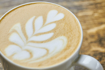 Flower latte art close up. Coffee foam texture.