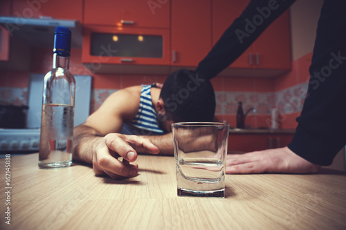 Fotografia, Obraz Sad depressed alcoholic man sitting at the table