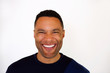 © mimagephotos - Close up laughing young african man against white background