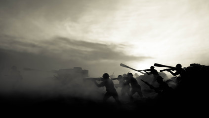 War Concept. Military silhouettes fighting scene on war fog sky background, World War Soldiers Silhouettes Below Cloudy Skyline At night. Attack scene. Armored vehicles. Tanks battle