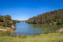 A View Of Blue Lac De Cavayere, Artificial Lake Near Carcassone With Green Vegetation 