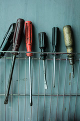 A set of old screwdrivers on a gray background.