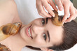 © Africa Studio - Young woman undergoing treatment with giant Achatina snails in beauty salon, closeup