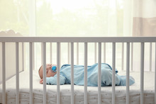 Cute Little Baby Sleeping In Cradle At Home