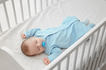 cute little baby sleeping in cradle at home