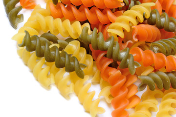 Wall Mural - Heap of colorful pasta on white background