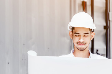 Engineering man reading blueprint at the construction site