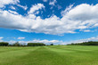Panorama of sky clouds and grass on meadow in summer