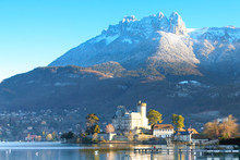 A View Of Duingt Castle On The Lake With Mountain In The Background In Annecy, France