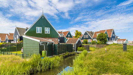 Wall Mural - Traditional Dutch village scene with wooden houses and canal