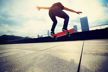 Young Woman Skateboarder Skateboarding At City