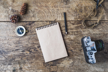 Wall Mural - Retro camera and compass on a wooden background. Travel concept