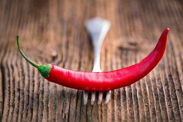 Wall Mural - Fresh red chilli pepper on a wooden table