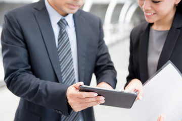 Wall Mural - Businesswoman and businessman using  tablet pc