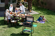 © LIGHTFIELD STUDIOS - family having barbecue while celebrating 4th july together, Independence Day concept