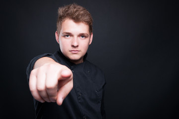 Male chef holding finger pointing towards the camera