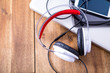 © Spectral-Design - Digital devices and Headphones on a wooden Desktop.