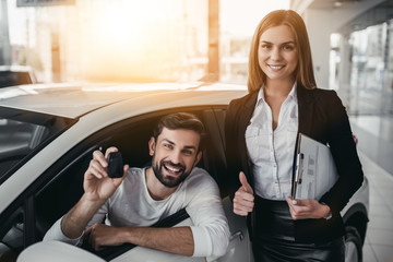 Poster - Salesperson with customer in car dealership