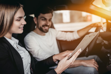 Poster - Salesperson with customer in car dealership