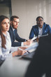 © alfa27 - Vertical image of business colleagues cooperating to achieve better results for their company