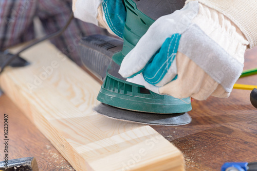 Man Sanding A Wood With Orbital Sander Buy This Stock Photo And