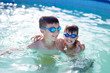 © sakkmesterke - Happy little kids playing in swimming pool at summer