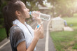 © nomadnes - woman drinking water bottle,woman refreshing healthy body by drink water,vintage tone