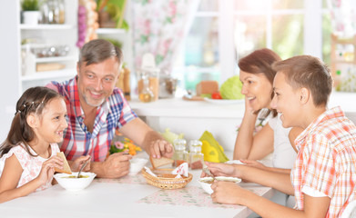 Wall Mural - Family with kids having breakfast