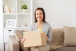 © Syda Productions - smiling woman opening cardboard box