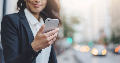 close-up of female hand holding modern smart phone outdoor