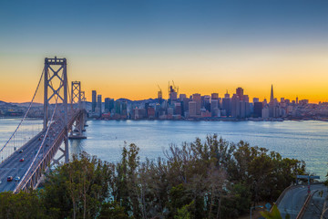 Fototapete - San Francisco skyline with Oakland Bay Bridge at sunset, California, USA