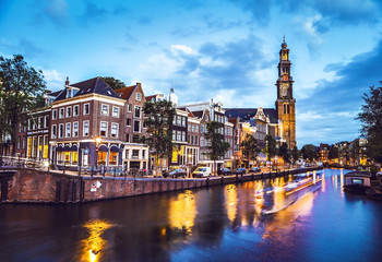 Wall Mural - The most famous canals and embankments of Amsterdam city at night. General view of the cityscape and traditional Netherlands architecture.