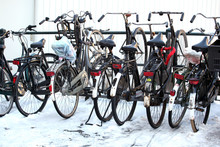 Bikes Parked In Winter Snow In Amsterdam, Netherlands.