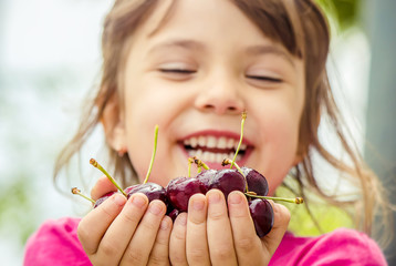 red cherry children's hands. selective focus. 