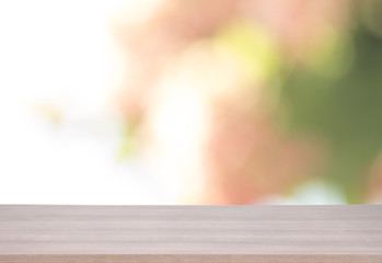 Wall Mural - Wood table top on green and pink bokeh background for product display montage.