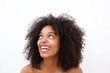 © mimagephotos - Close up carefree laughing black woman with bare shoulders