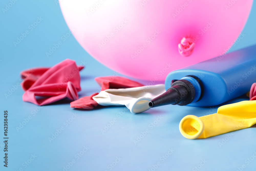 air-pump inflating a pink ballon on a blue background Stock Photo ...