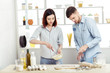 © Rychko Yevhen - happy Couple in love cooking dough in kitchen