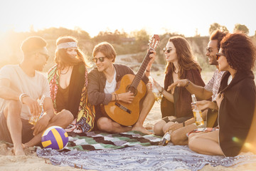 Wall Mural - Mixed race friends having fun at the beach