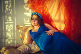 Fototapeta Dmuchawce - Beautiful happy pregnant woman in a blue dress.