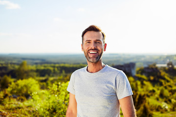 Portrait of happy adult man smiling outdoors