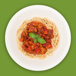 © Creatus - Spaghetti Bolognese on white plate isolated on green background, overhead view